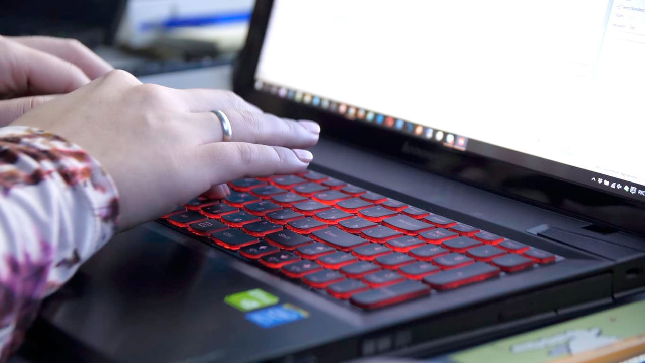 A person typing on a laptop computer.