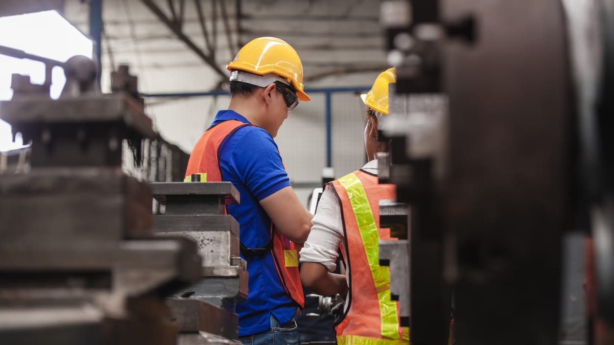 Two workers working in a factory.