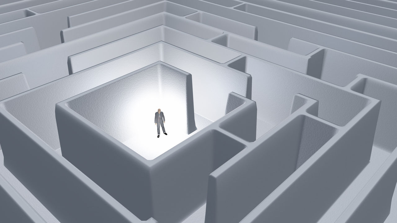 A man is standing in the middle of a maze.