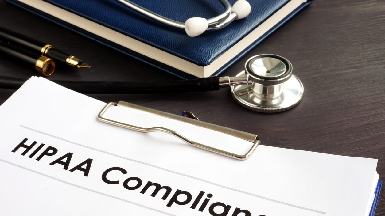 A clipboard with the word hipaa compliance next to a stethoscope.