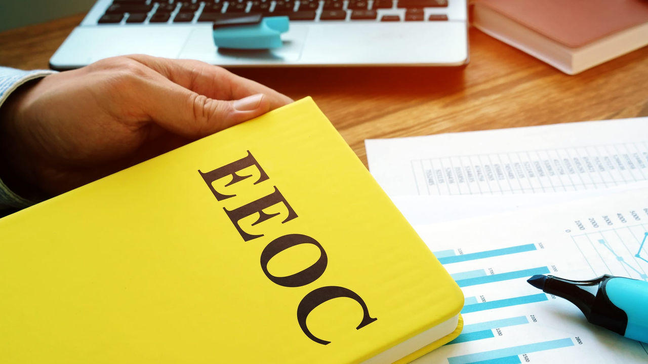 A person holding a yellow book with the word efoc on it.