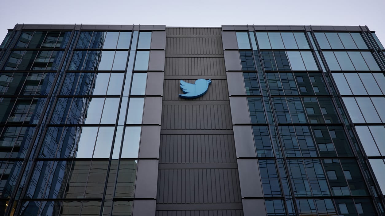 The twitter logo is seen on the side of a building.