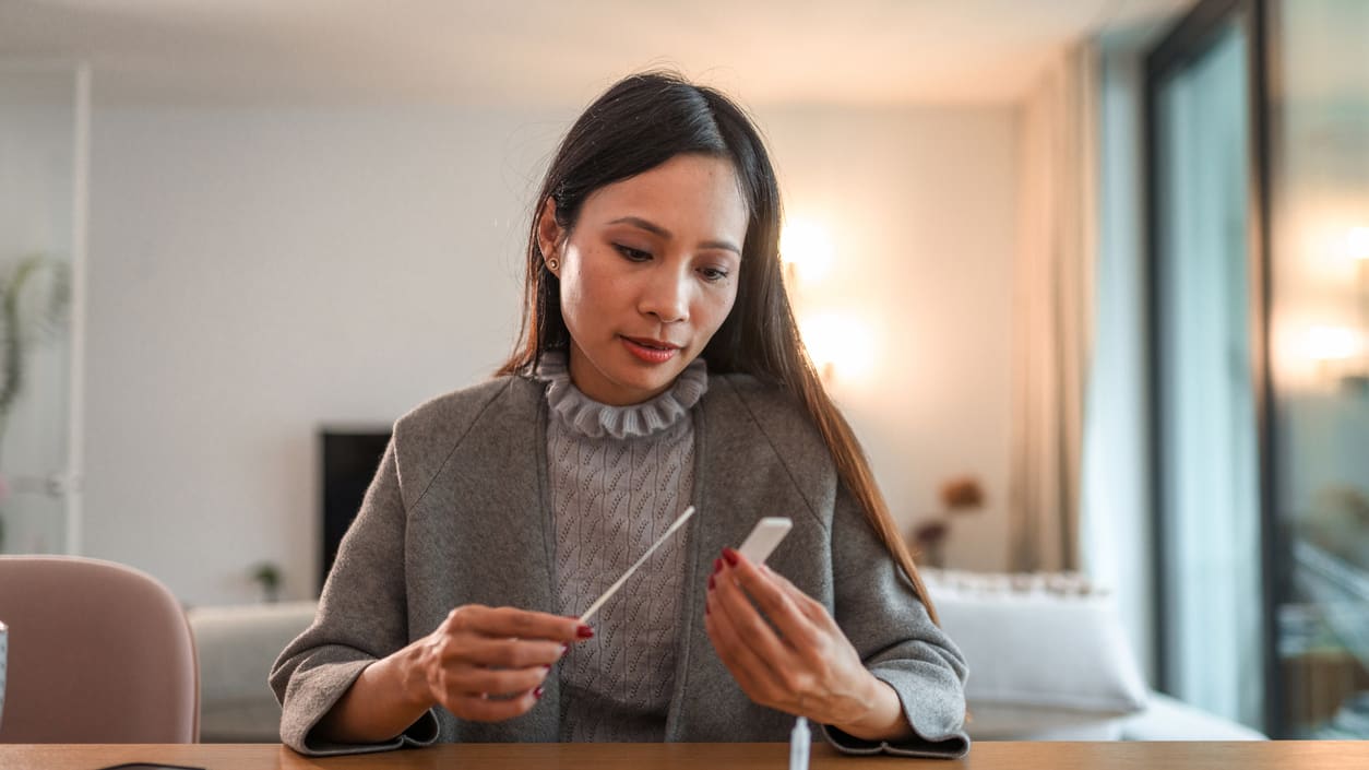 woman taking a blood test at home.