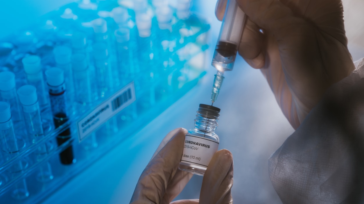 A person is holding a test tube in a laboratory.