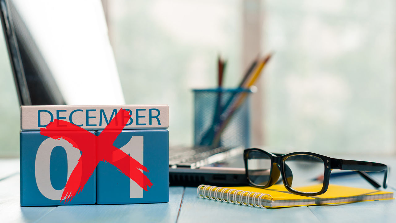 A calendar with the word december on it sits on a desk.