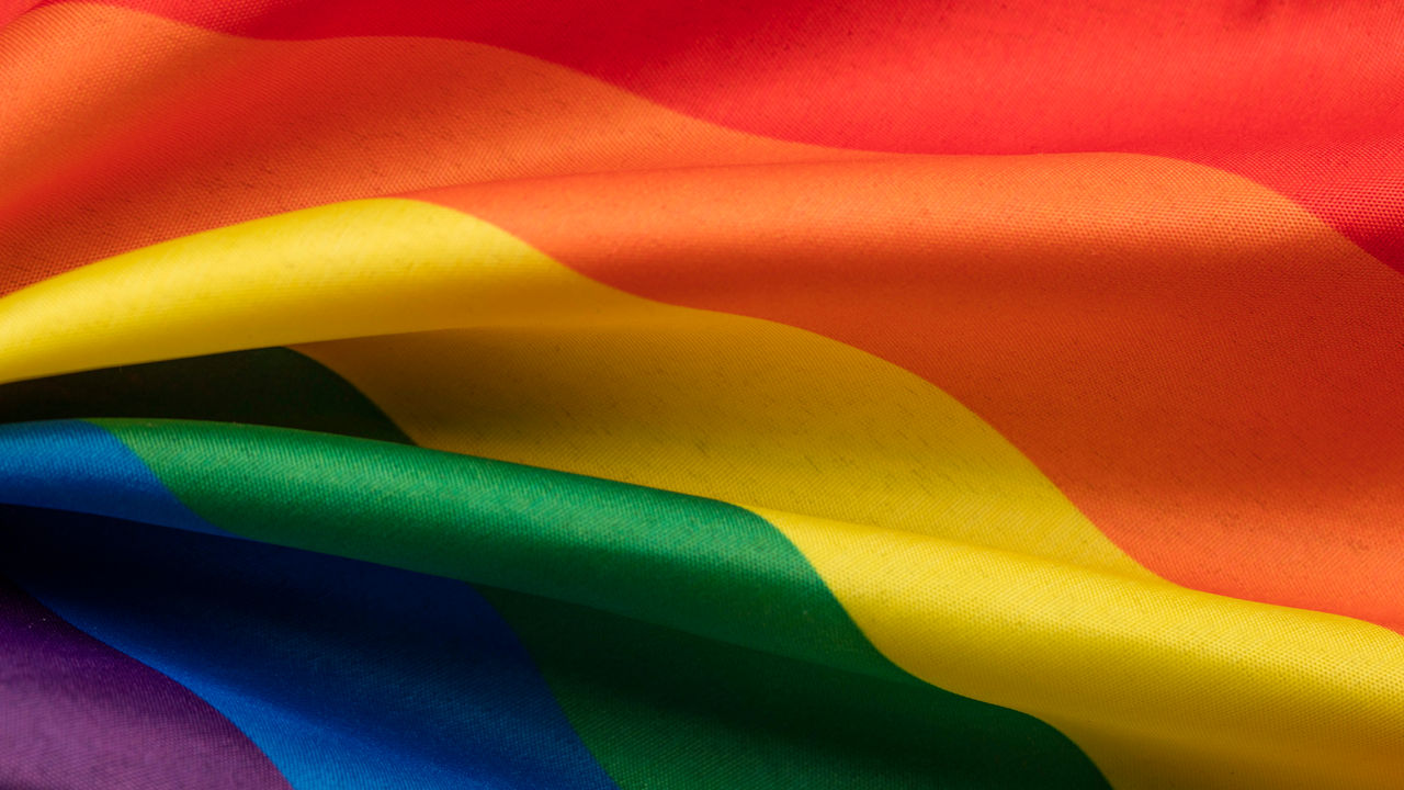 A close up of a rainbow flag.