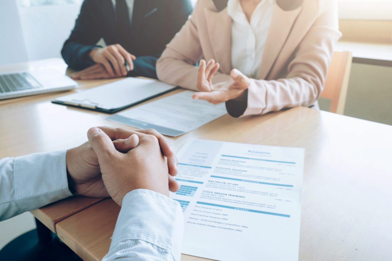Employees in discussion with paperwork in front of them