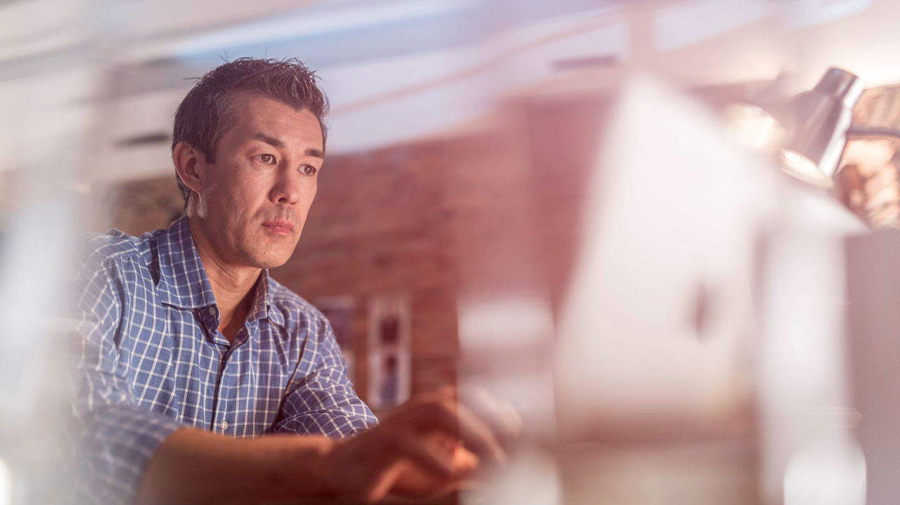 A man working on a computer in an office.