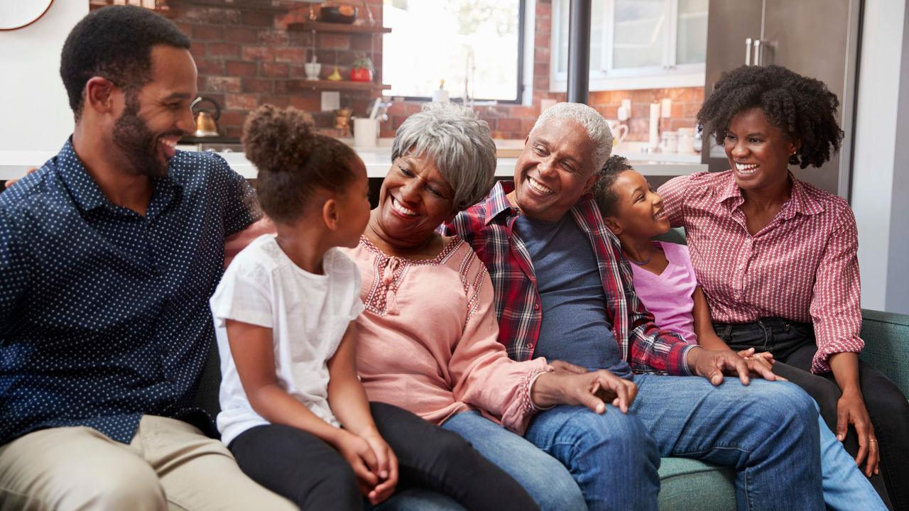 A family sitting on a couch in a living room.