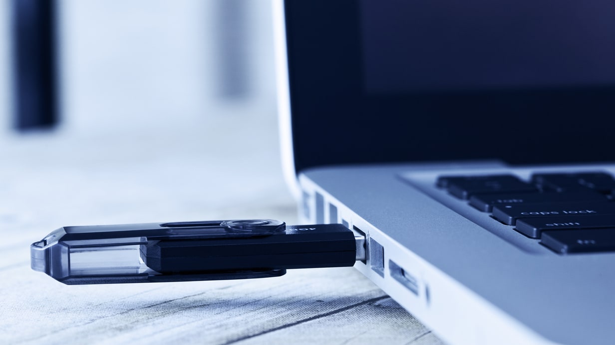 A usb drive connected to a laptop.