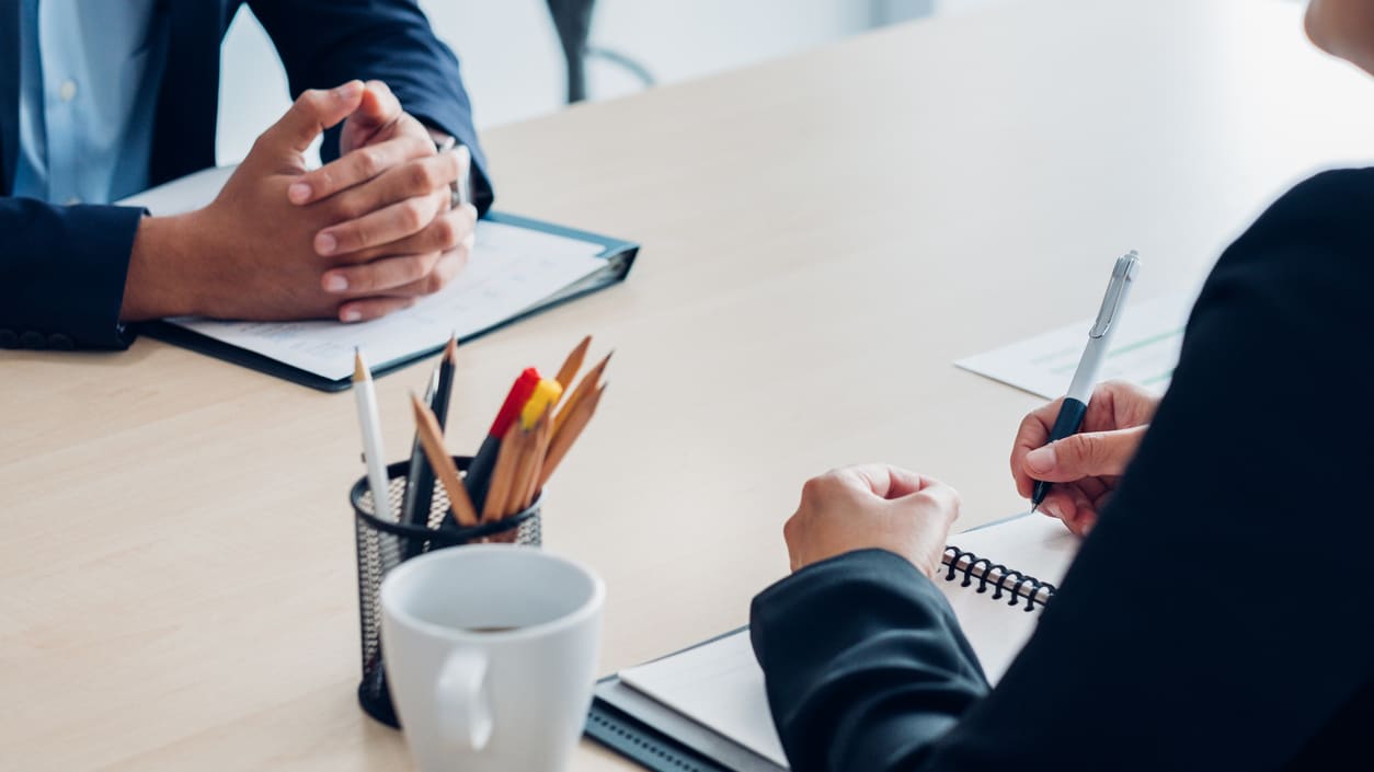 Two business people having a meeting at a desk.