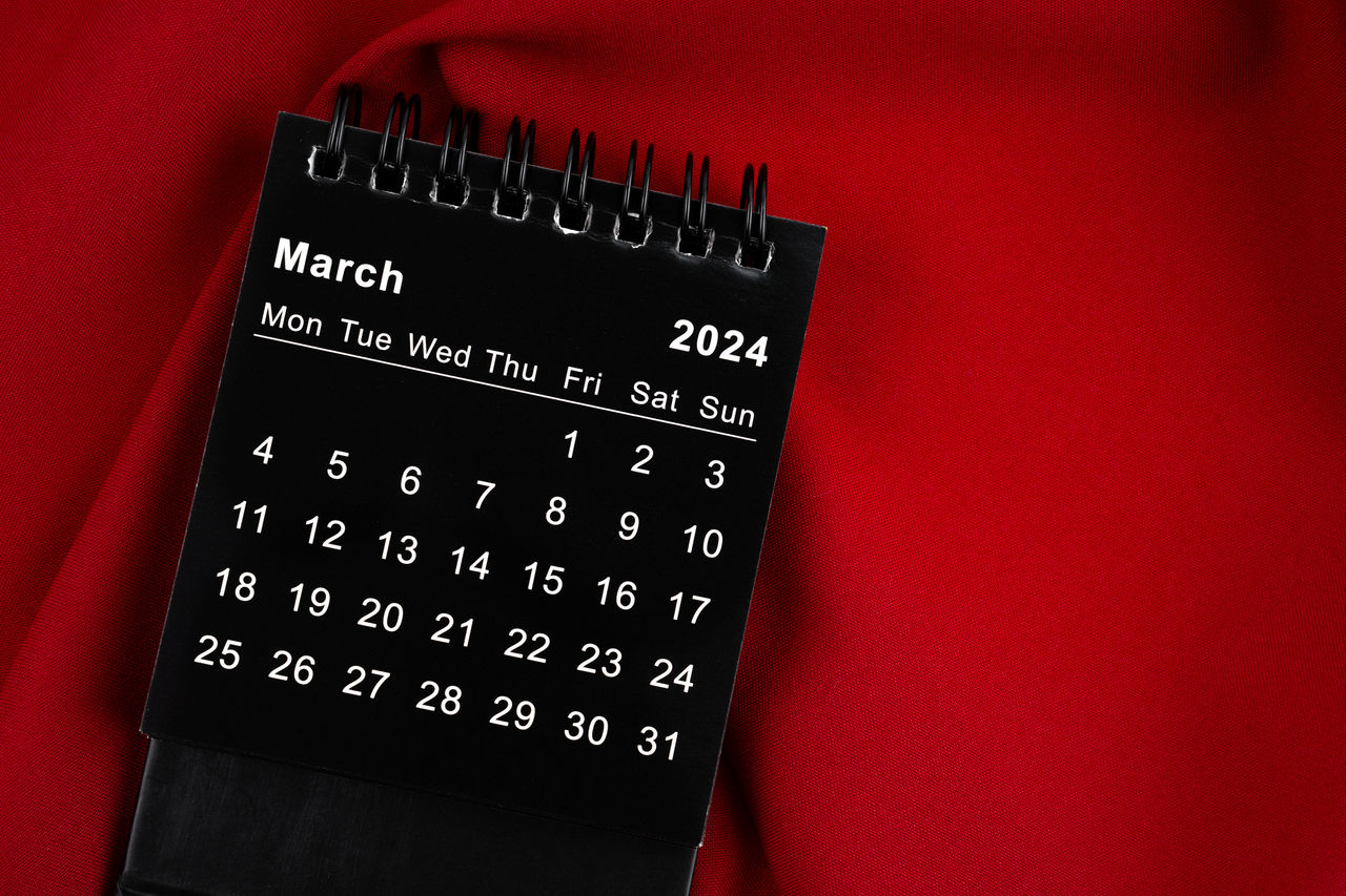 March 2024 spiral desktop calendar on textile.