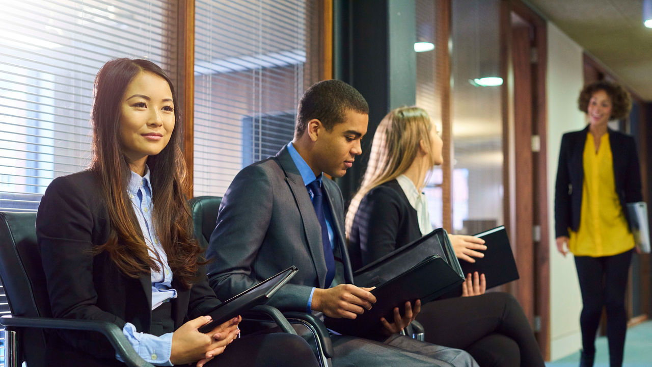 A group of business people sitting in an office.