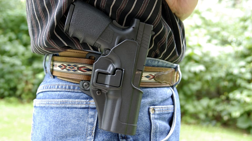 A man with a holster on his belt.