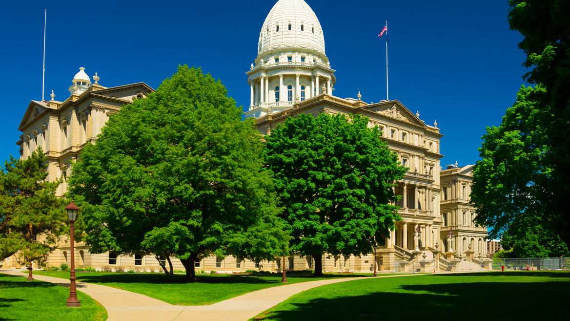 A large white building with a dome in the background.