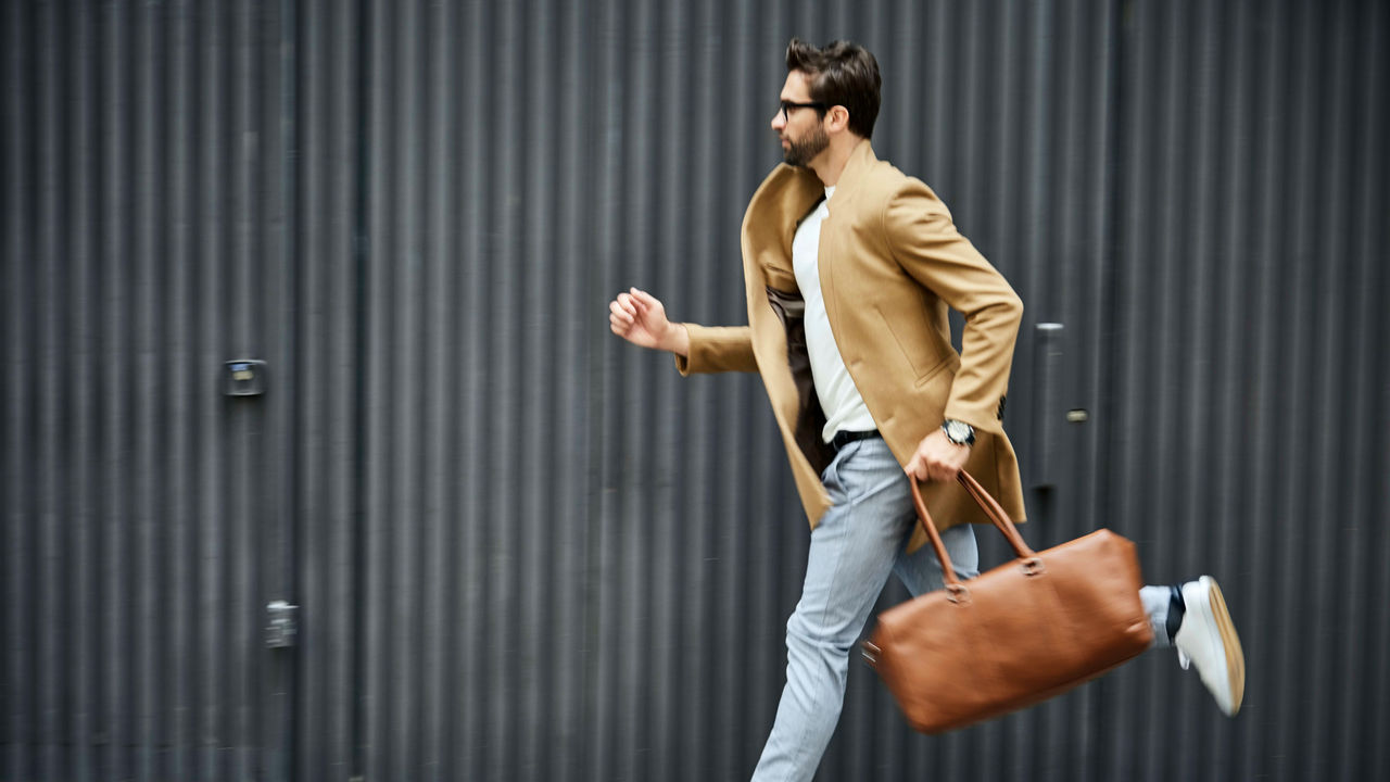 A man running with a brown bag.