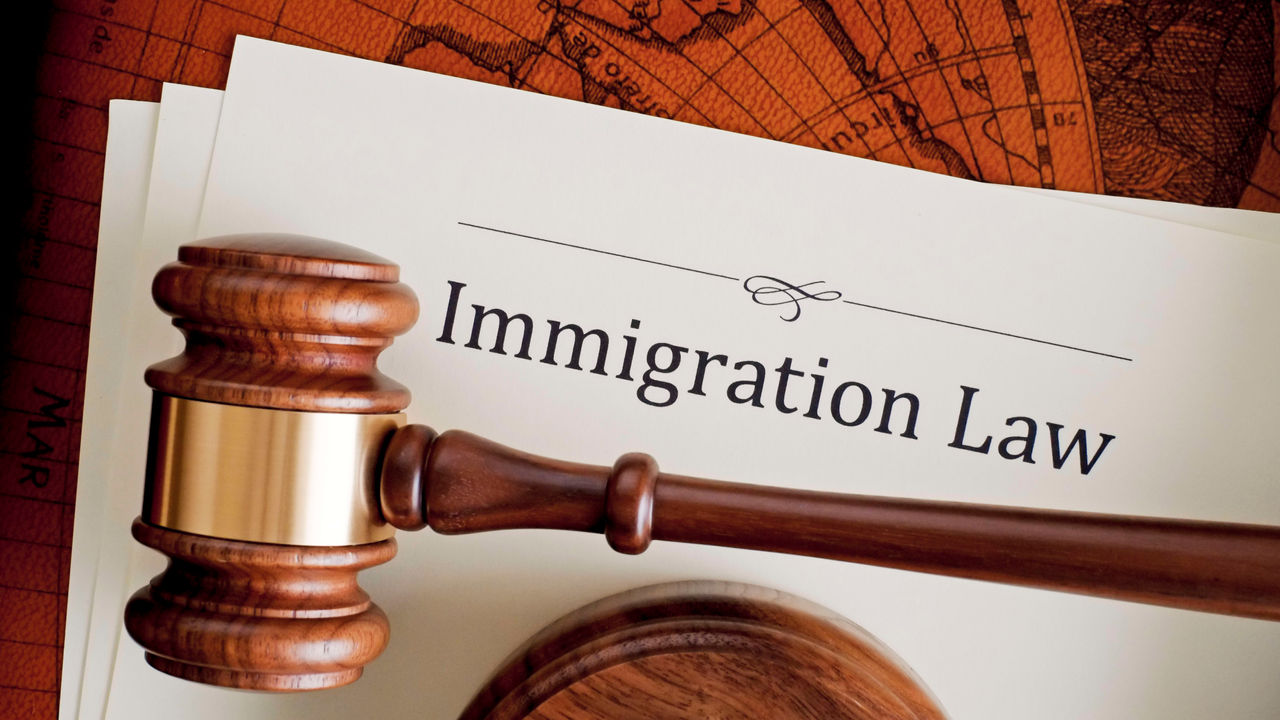 Immigration law with a gavel on top of a map.