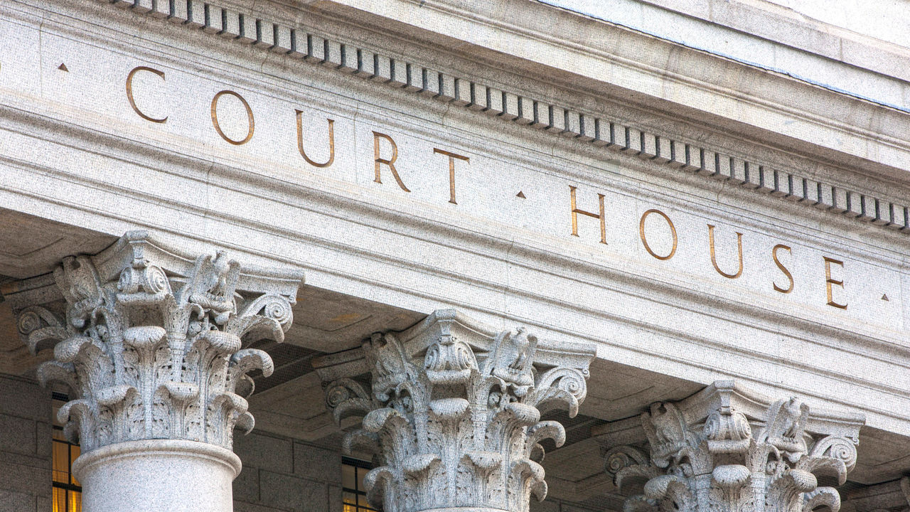 A building with columns and a sign that says court house.