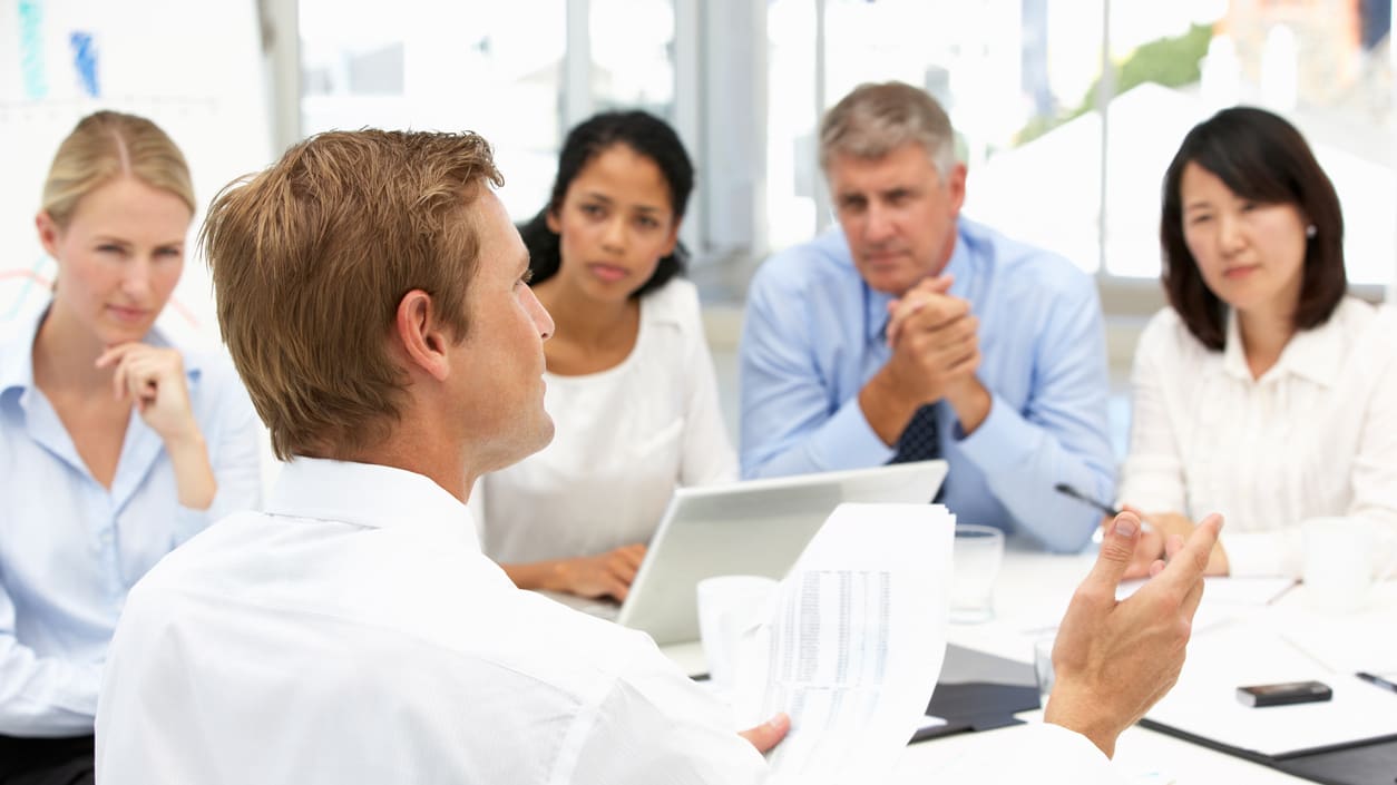 A group of business people sitting around a table.