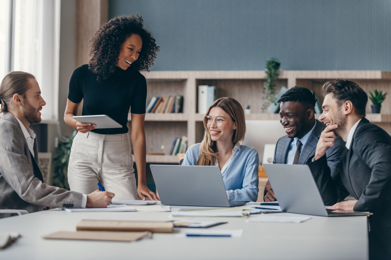 Diverse group of employees sitting at table