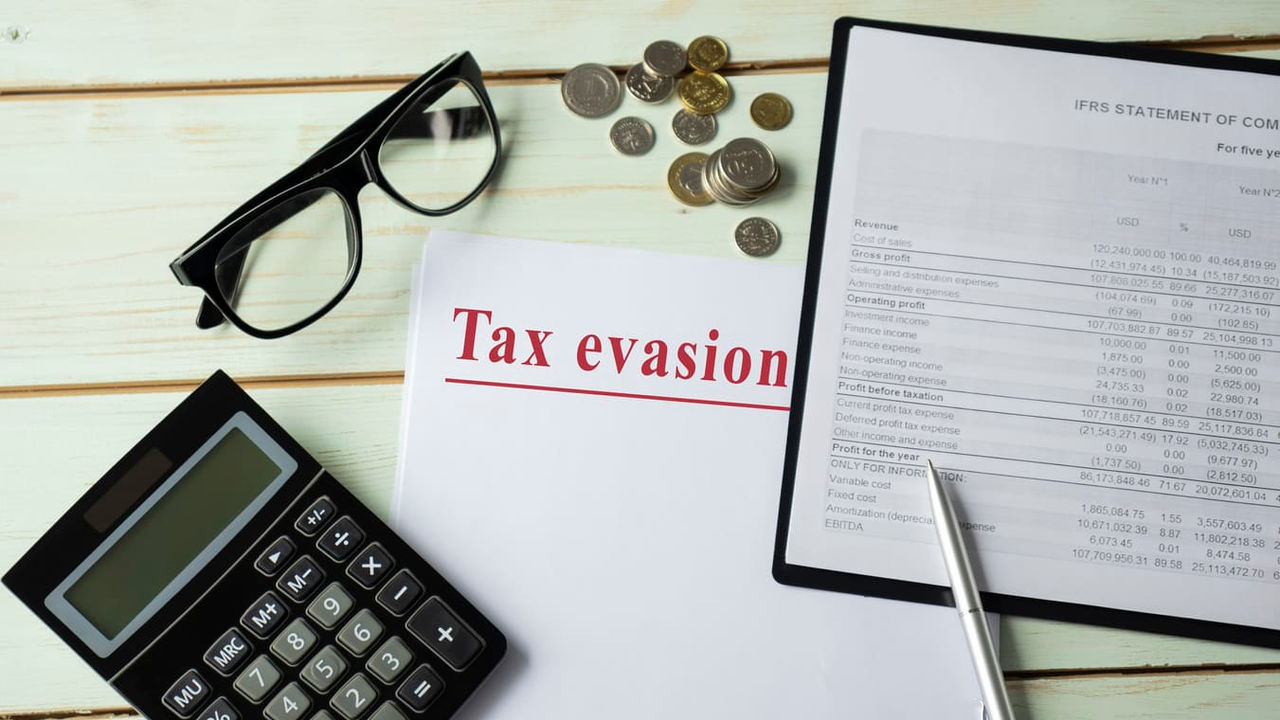 A document with the word tax eviction next to a calculator and glasses.