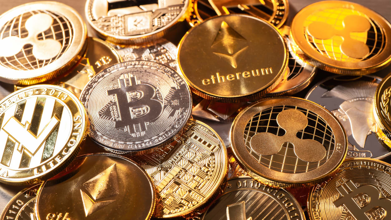 A pile of bitcoin coins on a table.