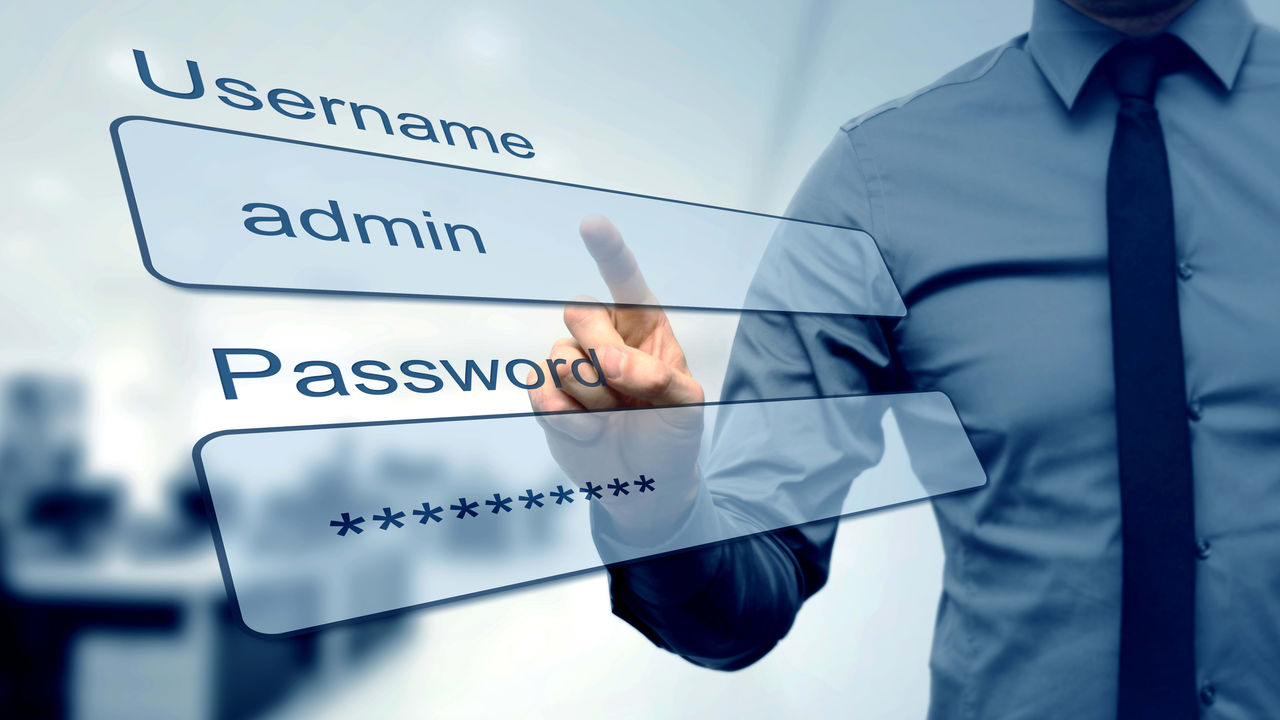 A man is pointing at a login screen.