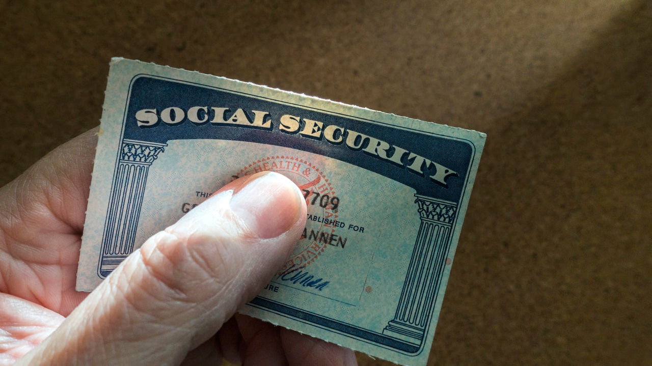 A person holding a social security card.