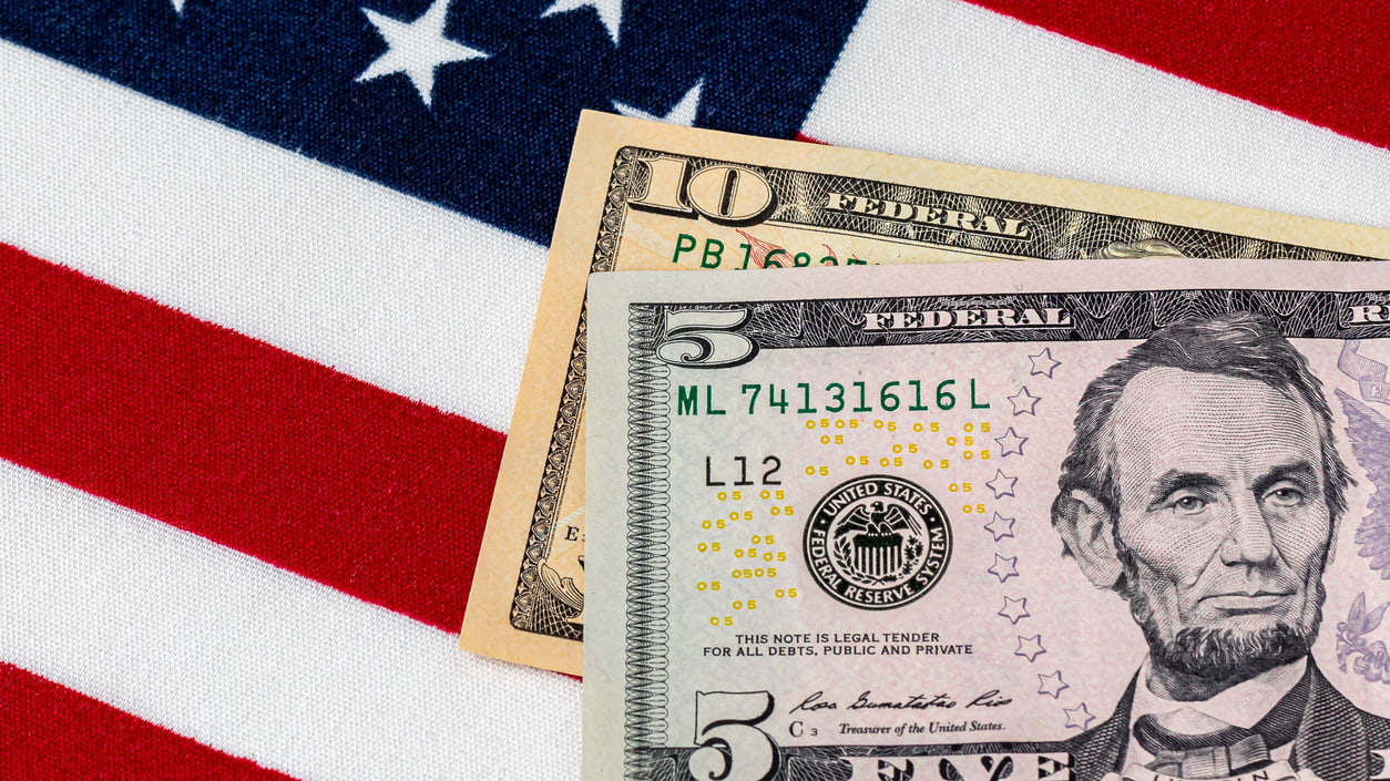 A lincoln dollar bill and an american flag.