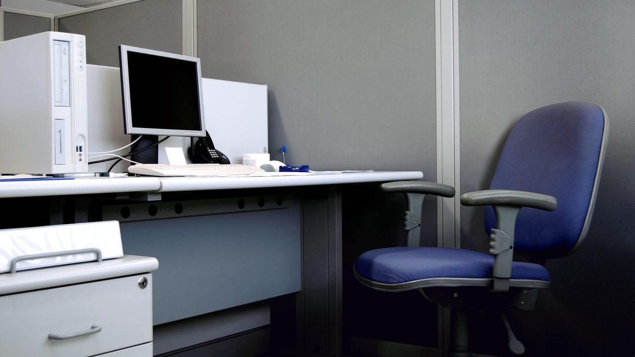 A blue chair on a desk.