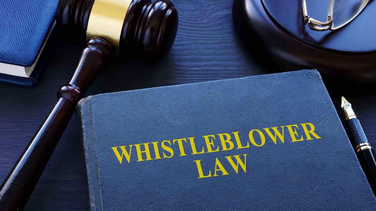 A book with the word whistleblower law on it.