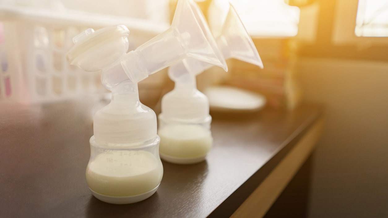 Two breast pumps sitting on a table.