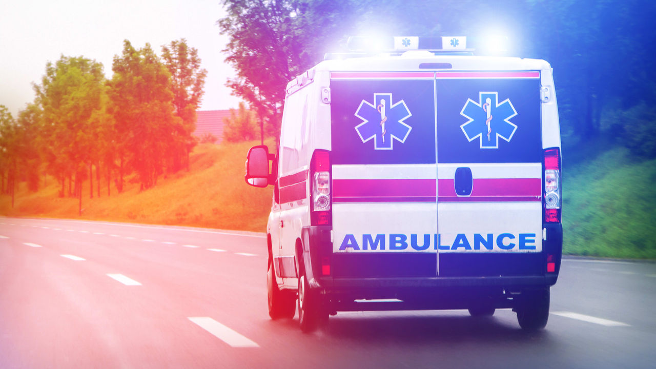An ambulance driving down the road.