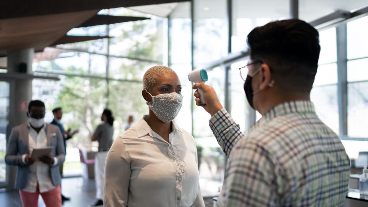 A man wearing a face mask and a woman wearing a face mask.