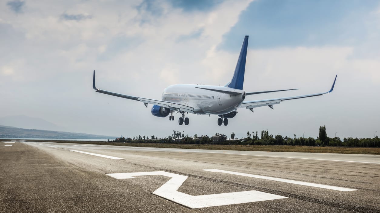 An airplane is taking off from an airport runway.