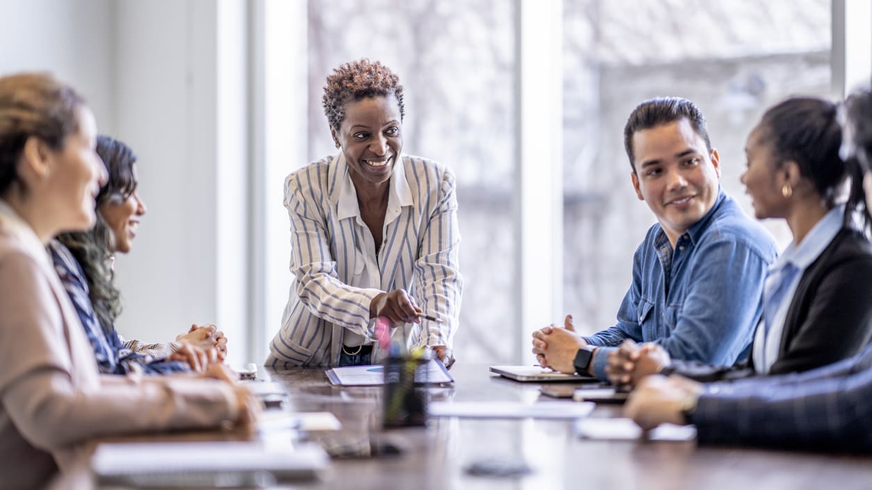 A group of business people sitting around a conference table.