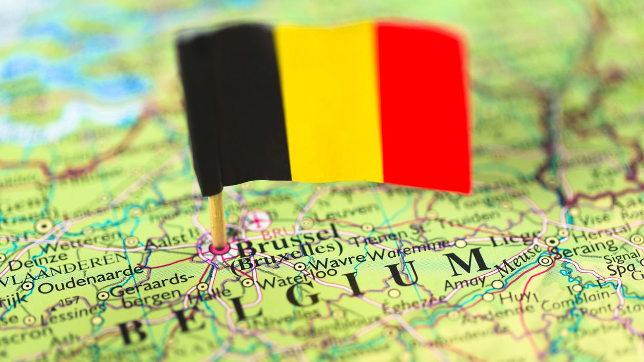 A flag is pinned on a map of belgium.