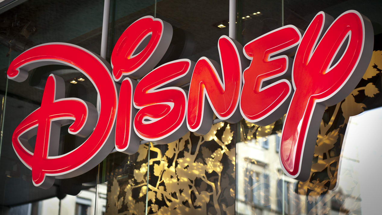 The disney logo is displayed on a store window.