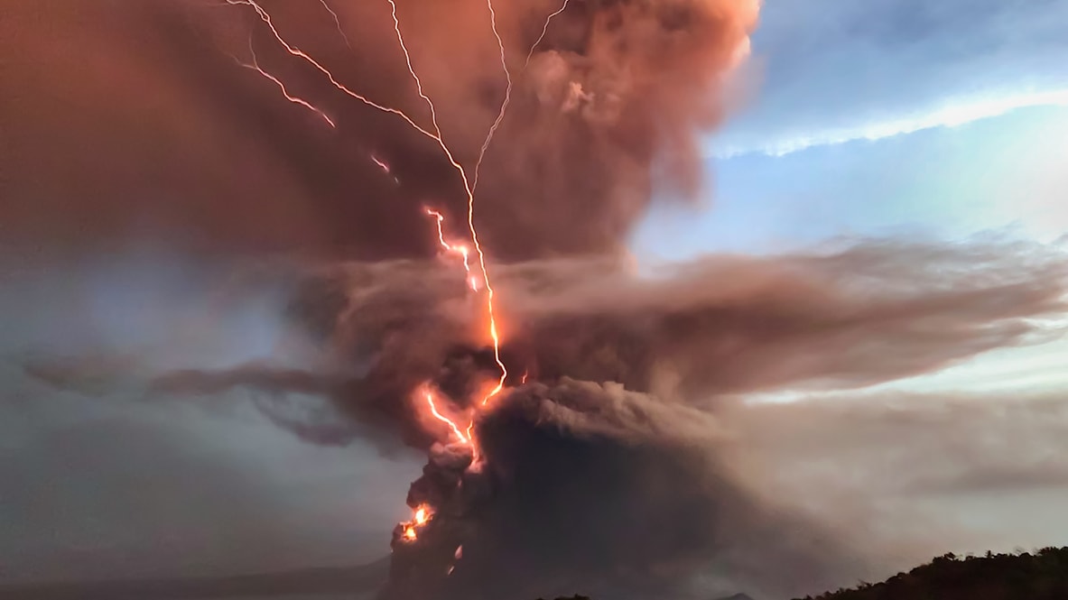 A lightning bolt is coming out of a volcano.