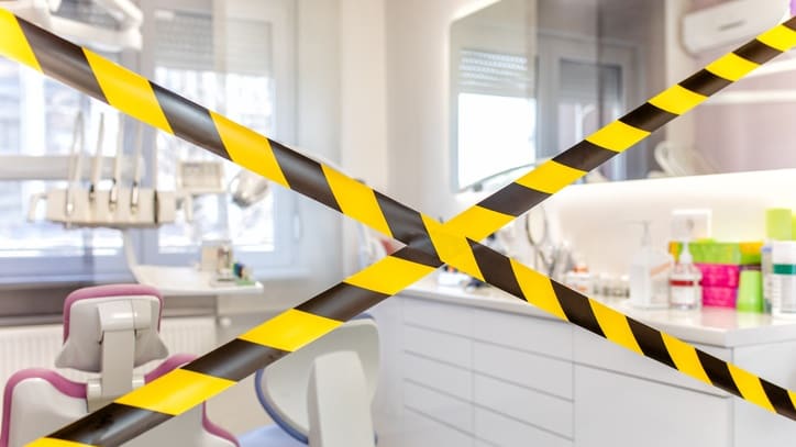 A black and yellow caution tape in a dentist's office.