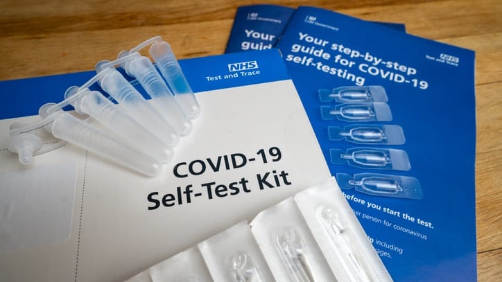 A covid-19 self-test kit is sitting on a table.
