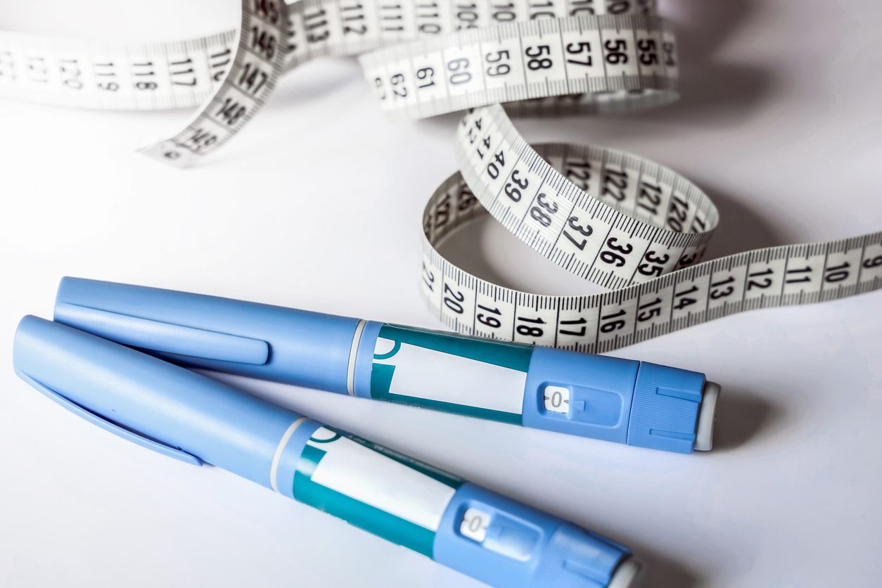 a GLP-1 drug with measuring tape