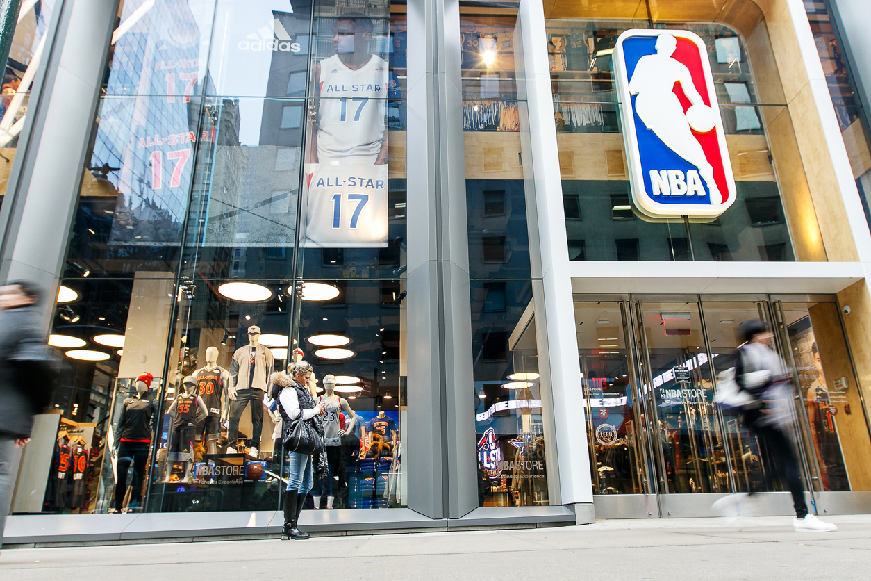 People walking by an NBA store in Manhattan