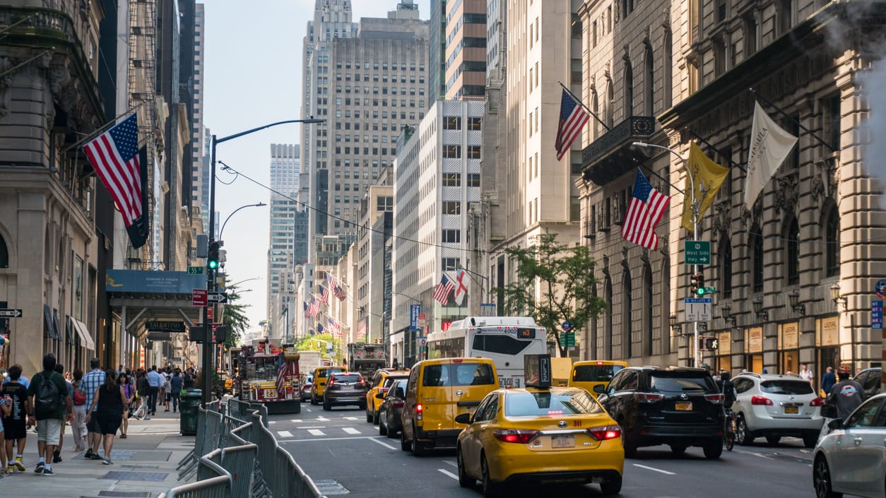 A street in new york city with a lot of traffic.