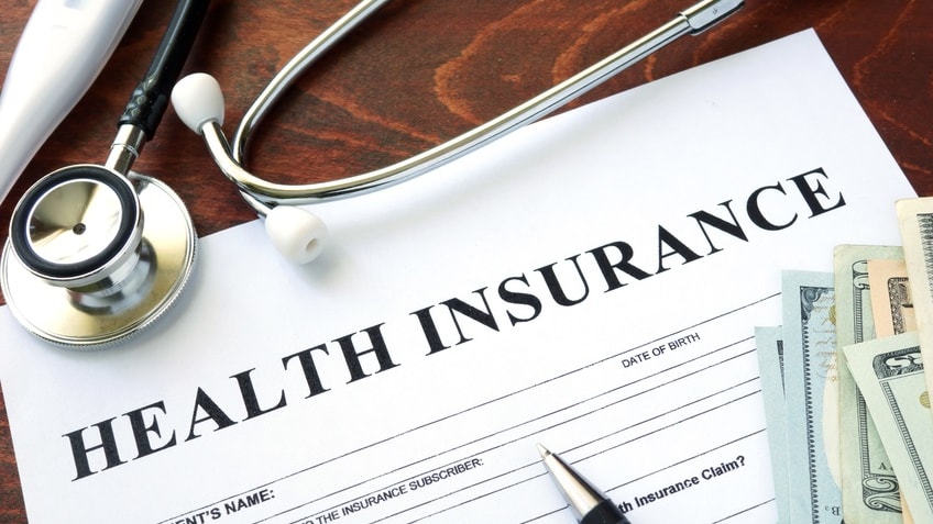 A health insurance document with a stethoscope and money.