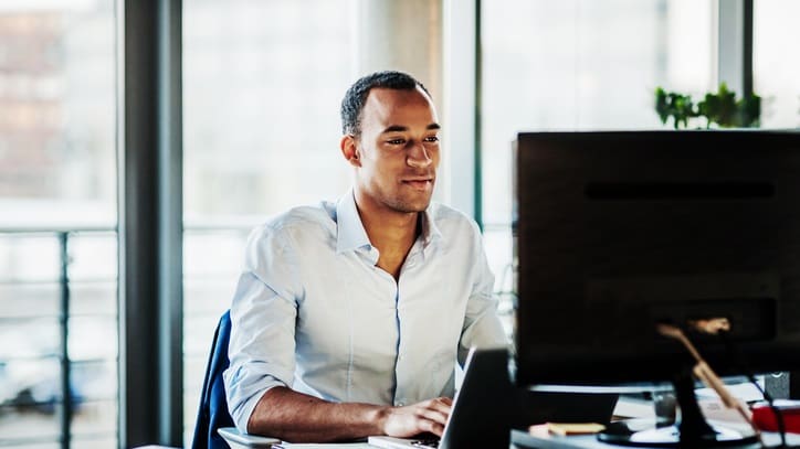 A man working on a computer in an office.