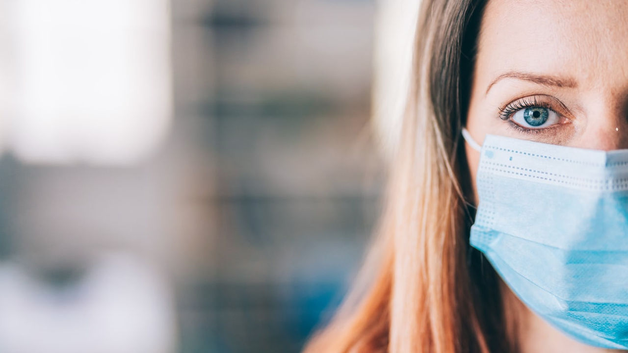 A woman wearing a surgical mask.