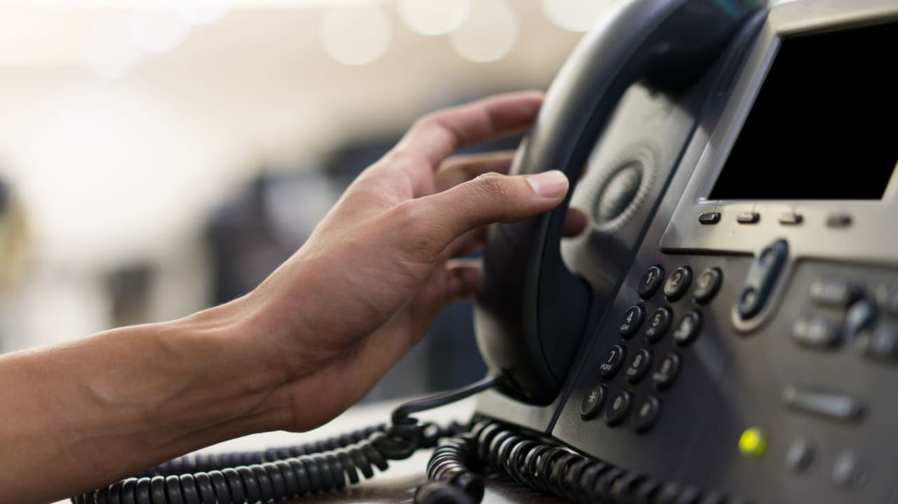 A person is using a telephone to make a call.