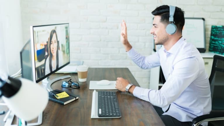 A man is on a video call with a woman on a computer.