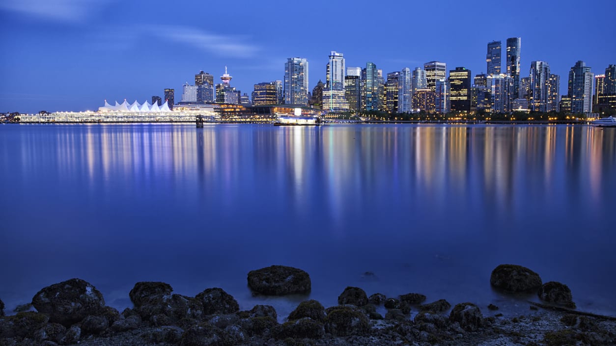 Vancouver skyline reflected in the water at dusk.